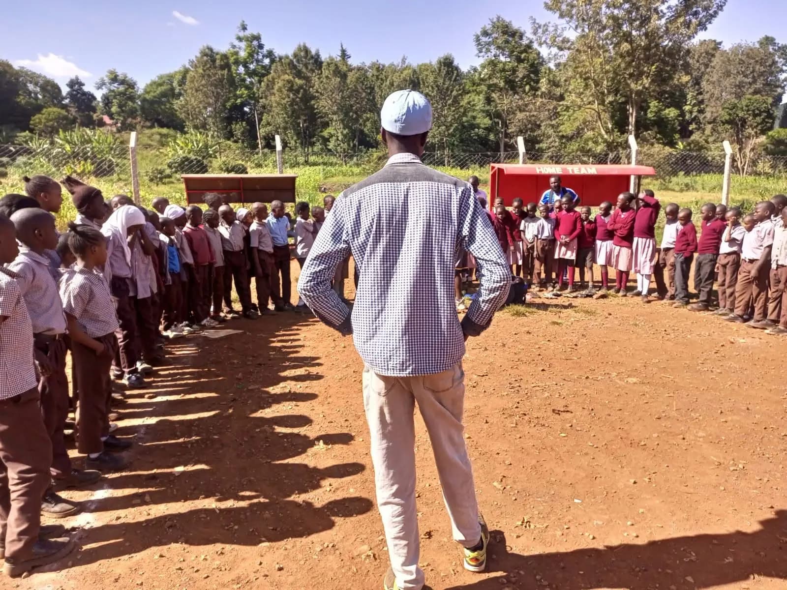 Kibagare school children gathered in a circle for the first practices