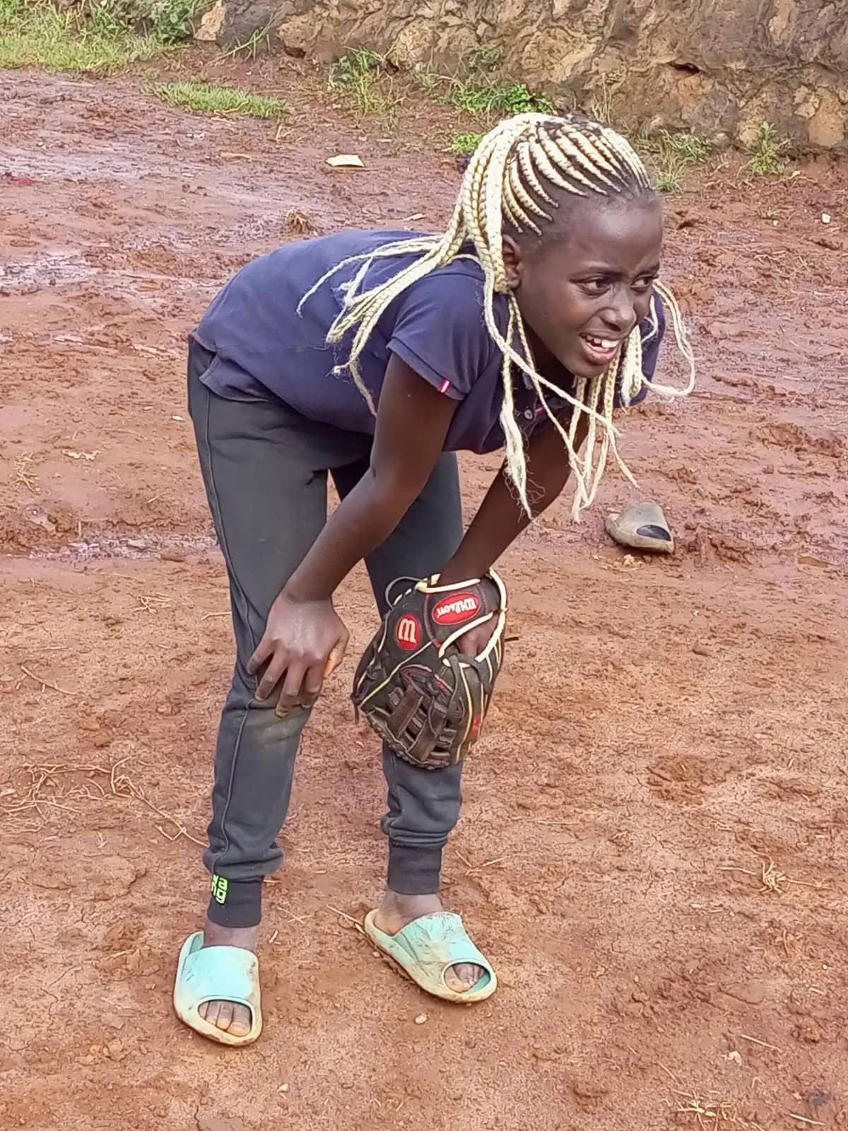 A young Angel in ready position on a muddy field